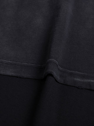 Close-up of the side seam and underarm junction on the 260 GSM cotton tee, showing distressed topstitching