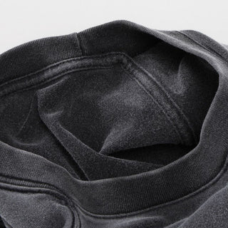 Interior view of charcoal Celestial Drifter tee neckline showing reinforced collar stitching and construction
