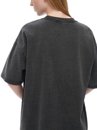 Woman modeling oversized dark gray Awaken Your True Self vintage wash tee from behind showing dropped shoulder