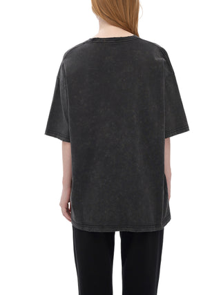 Woman modeling oversized acid-washed dark gray Celestial Drifter tee from behind showing relaxed boxy fit