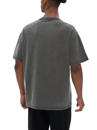 Man modeling oversized acid-washed gray Celestial Drifter tee from behind with relaxed drop-shoulder fit