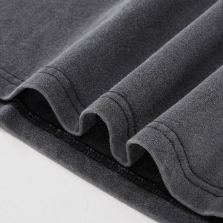 Close-up of double-stitched hem detail on charcoal gray heavyweight Yin Yang cotton t-shirt