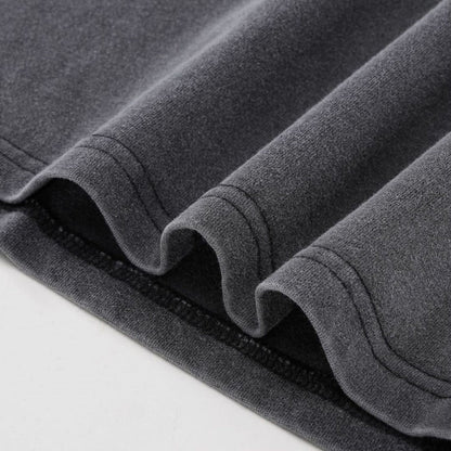 Close-up of double-stitched hem detail on charcoal gray heavyweight Yin Yang cotton t-shirt