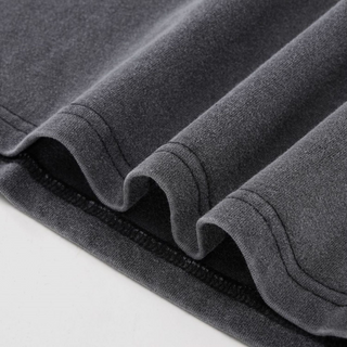 Close-up of double-stitched hem detail on gray acid-wash Chakra Vision Fluffy Vintage tee