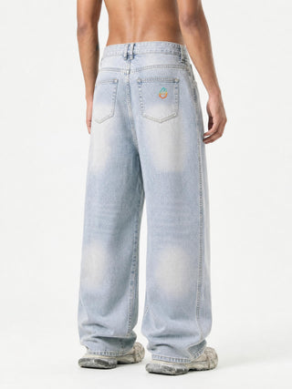 Model wearing DMT.exe vintage sunfade barrel leg jeans, alternate angle