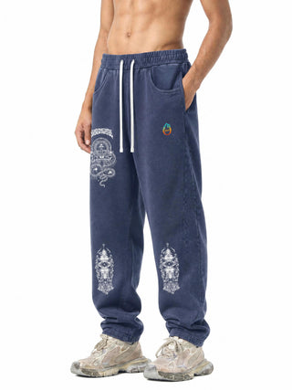 Close view of Spirit Molecule sweatpants showing the serpent mandala thigh print and teal to orange flame mark