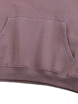 Close-up of Existential Oversize Fleeced Hoodie kangaroo pocket and ribbed hem in mauve