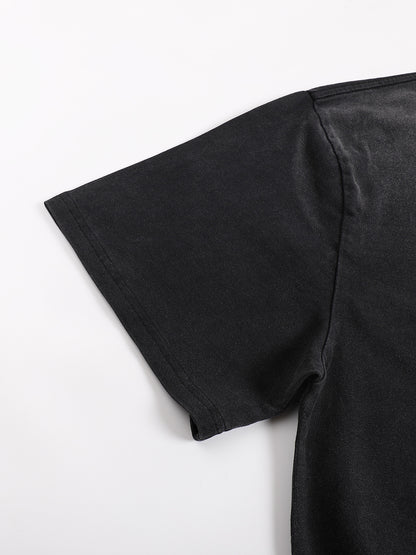 Close-up of black sunfaded Ethereal Muse tee showing drop shoulder seam and construction