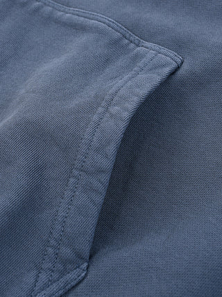 Close-up detail of blue sunfade Embrace The Chaos hoodie fabric texture showing soft fleece