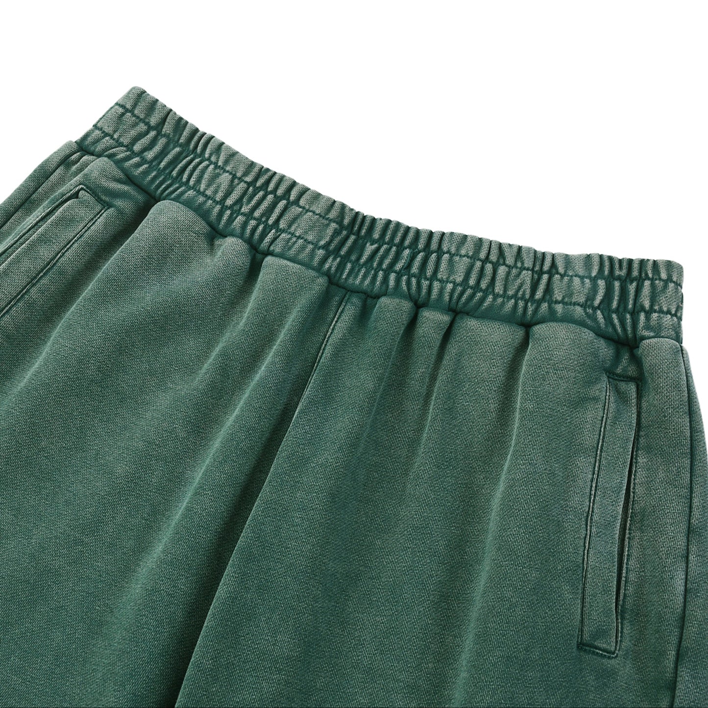 Green sweatpants with an elastic waistband on a white background