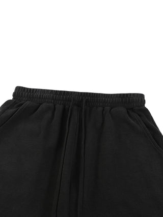 Close-up of elastic waistband and waffle knit texture on dark mineral wash Existential shorts