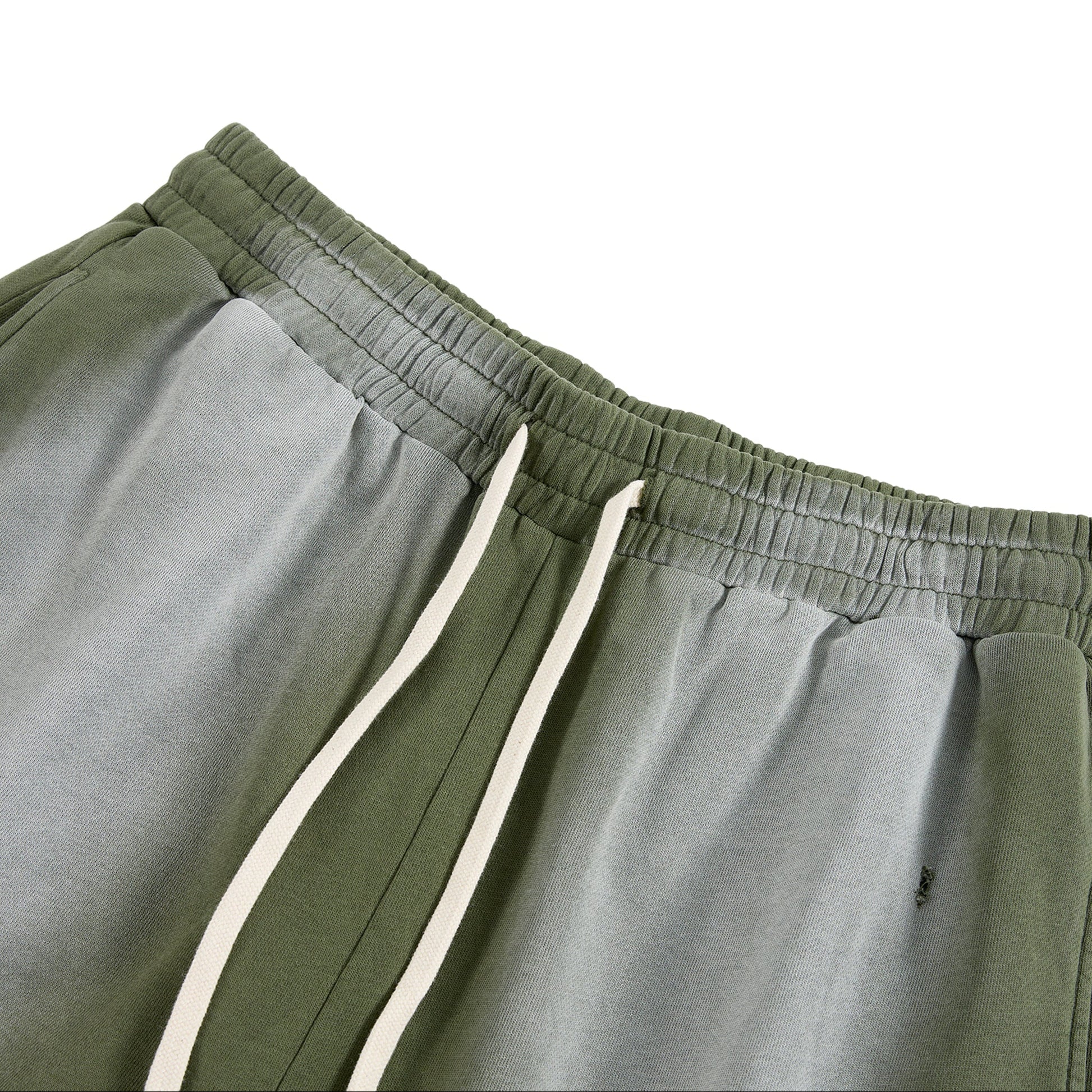 Green sweatpants with white drawstrings on a white background