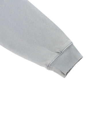 Close-up detail of the ribbed cuff and raw edge distressing on the 400 GSM mineral wash hoodie