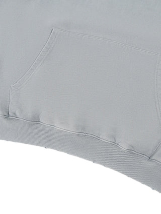 Close-up detail of the ribbed hem and heavyweight cotton texture on the 400 GSM mineral wash distressed hoodie