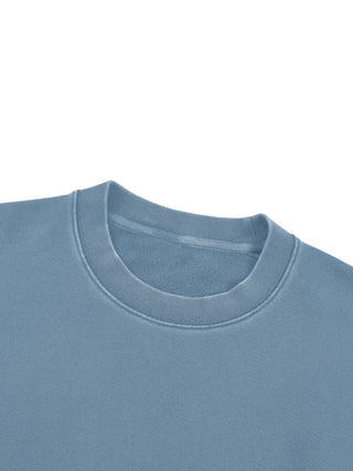 Close-up of the ribbed crewneck collar on the 360 GSM vintage-washed cotton sweatshirt in jeans blue