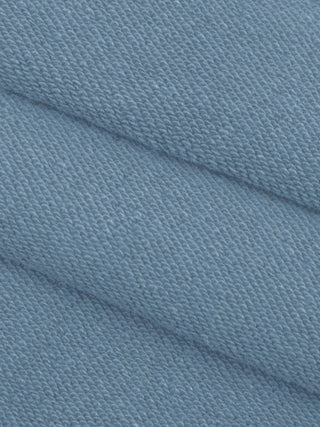 Macro view of the textured 360 GSM cotton knit in jeans blue