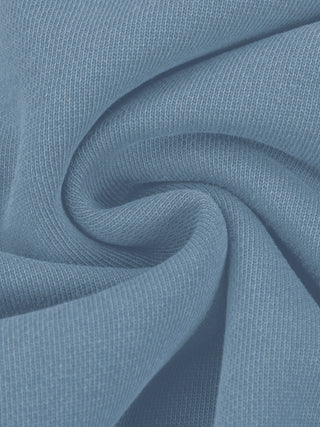 Draped fold of the 360 GSM pure cotton fabric showing the weight and vintage-washed surface in jeans blue