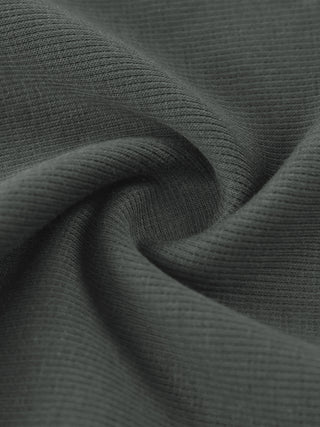 Macro of the ribbed cotton on the gray Existential waffle knit sweatpants, twisted to show the stretch and density of the 340 GSM fabric