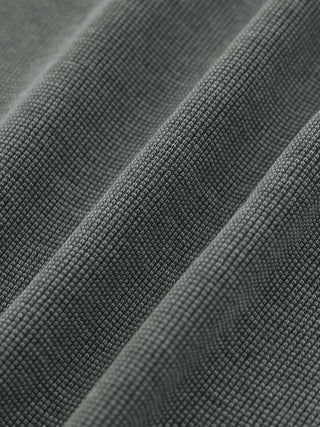 Macro of the waffle knit grid texture on the gray Existential heavyweight sweatpants in raking light