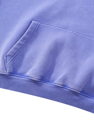 Detail of the kangaroo pocket and ribbed hem on the PsySquatch boxy fleece hoodie, shown in Purple, with the vintage wash fading at the pocket edge and hem