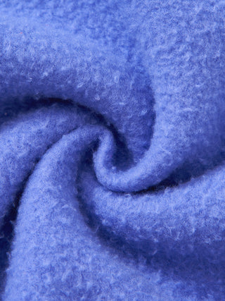 Close up of the brushed fleece interior of the PsySquatch boxy hoodie in Purple, twisted to show the soft pile and the loft of the 390 GSM knit