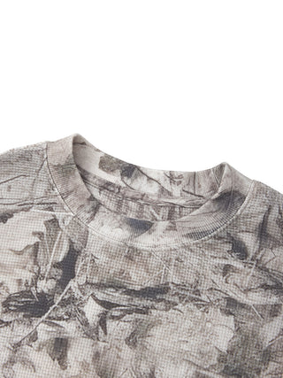 Angled collar and shoulder detail of the PsySquatch tree camo waffle long sleeve, showing the ribbed crew neck construction and the drop shoulder seam under the all over print