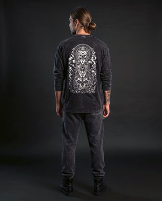 Model wearing the Oracle acid wash relaxed fit long sleeve in Black Beauty, back view, showing the full back artwork.