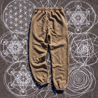 Back view of the Paradigm heavyweight snow wash joggers in warm khaki Brown on chalk sacred geometry asphalt, showing the plain back, gathered elastic waistband and ribbed ankle cuffs.