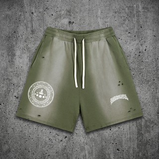 Olive green Meditative sun fade heavyweight shorts on concrete, with white drawstring, a white meditative mandala graphic on one leg and Phantasmagorical text on the other.