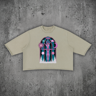 Dissolution of Ego mineral wash raw-hem sweater tee in apricot, heavyweight boxy cotton tee with psychedelic print on a concrete backdrop