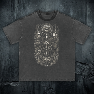 Toadstool Trance 250 GSM fluffy vintage washed tee in dark charcoal gray, styled flat lay on concrete backdrop, large psychedelic mushroom front print with radiant all-seeing eye, skull, woman's face, and lotus meditator