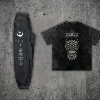 Existential Snow Wash Set, back view — snow-wash black heavyweight tee with a white dragonfly and Flower of Life sacred-geometry print, shown beside joggers with crescent-moon and alchemical line art down the leg.