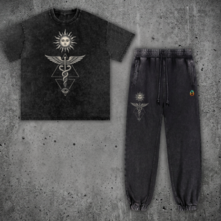 Inner Alchemy Snow Wash Set by Phantasmagorical — snow-wash charcoal heavyweight tee and matching joggers, front view, with a winged caduceus, celestial sun, and all-seeing eye graphic in cream and silver.