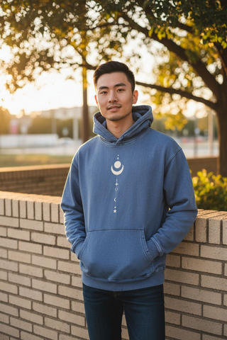 Man wearing Existential Oversize Fleeced Hoodie in light blue with celestial front design outdoors