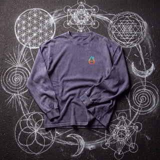 Front of the Spirit Animal acid wash oversized long sleeve tee in Purple Haze, styled on dark asphalt covered in white chalk sacred geometry, with the Phantasmagorical logo on the left chest.