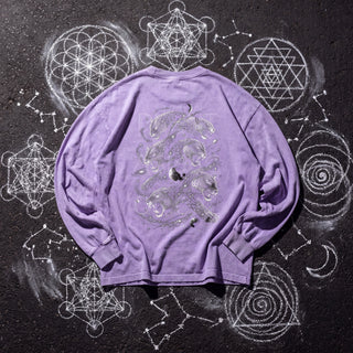 Back of the Spirit Animal acid wash oversized long sleeve tee in Purple, styled on dark asphalt covered in white chalk sacred geometry, showing leopards stacked among the stars.