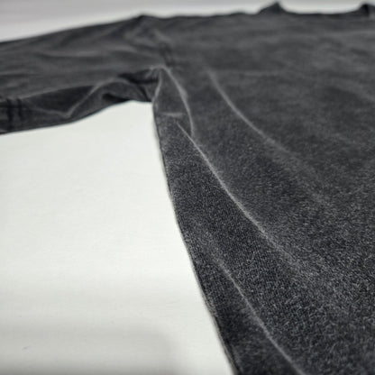 Side angle flat lay of Spectral Knight Fluffy Vintage tee showing charcoal snow wash finish